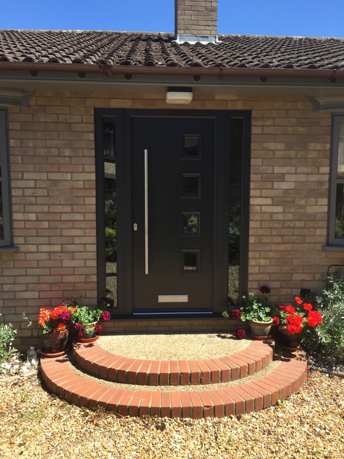 Black front door with glazed side panels fitted near Cambridge